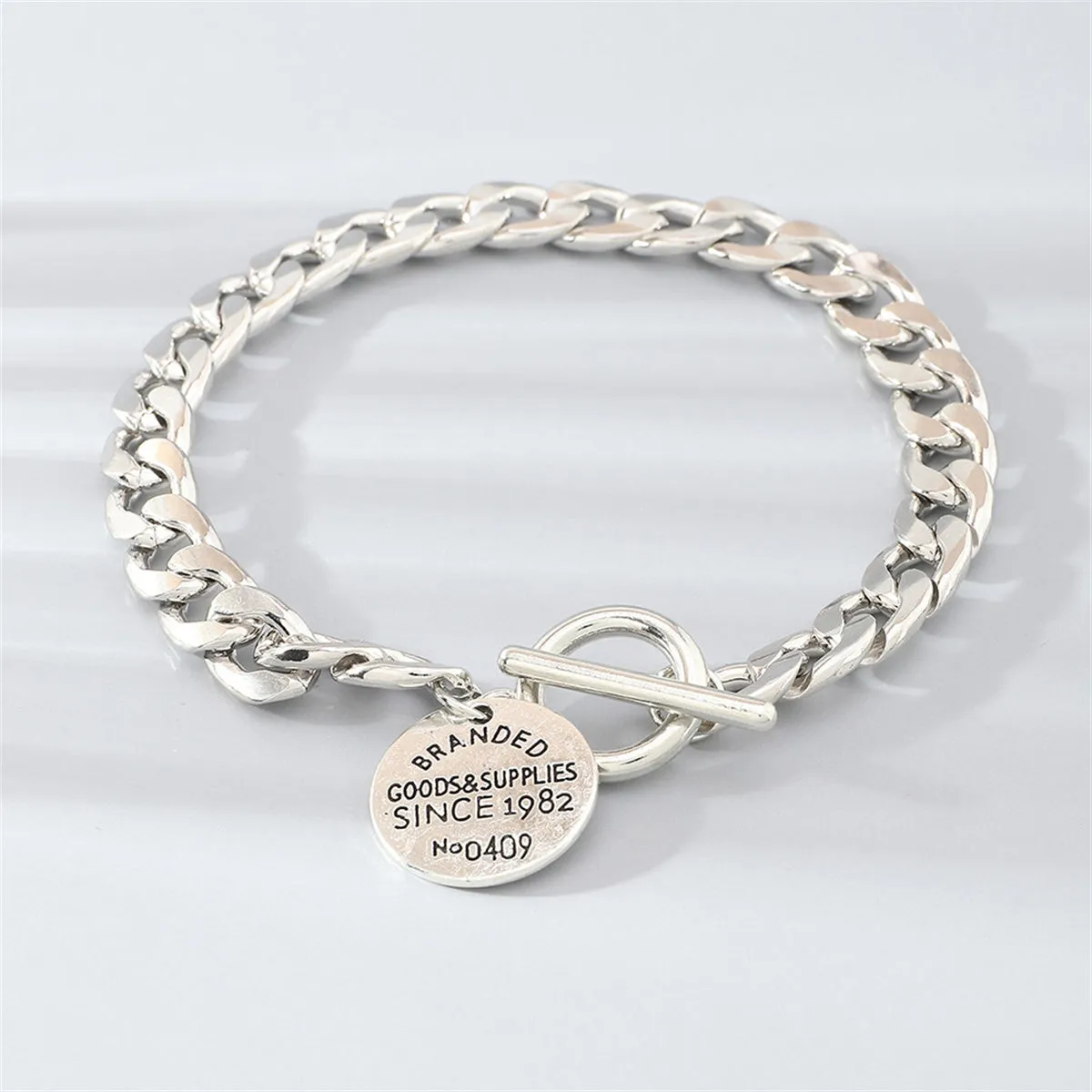 Silver-Plated 'Goods & Supplies' Curb Chain Toggle Bracelet